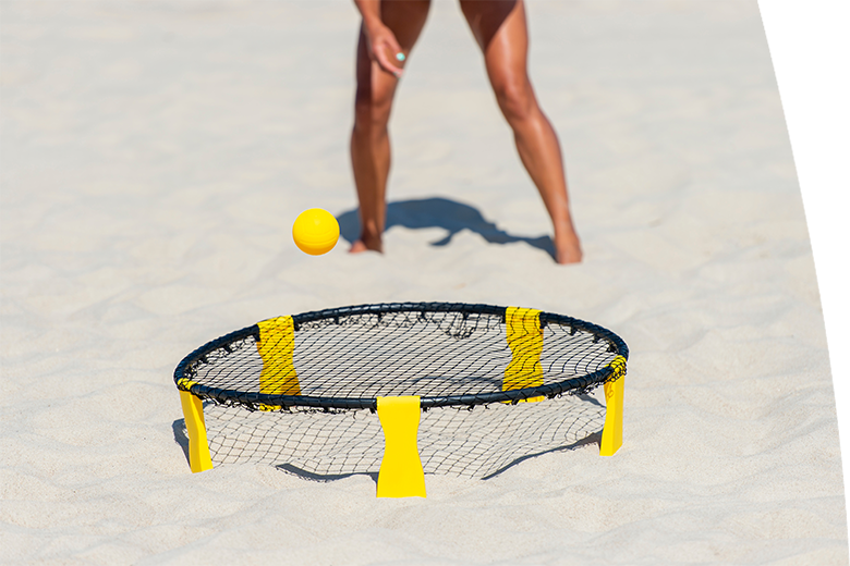 Summer game. Spike ball with yellow ball on sand.